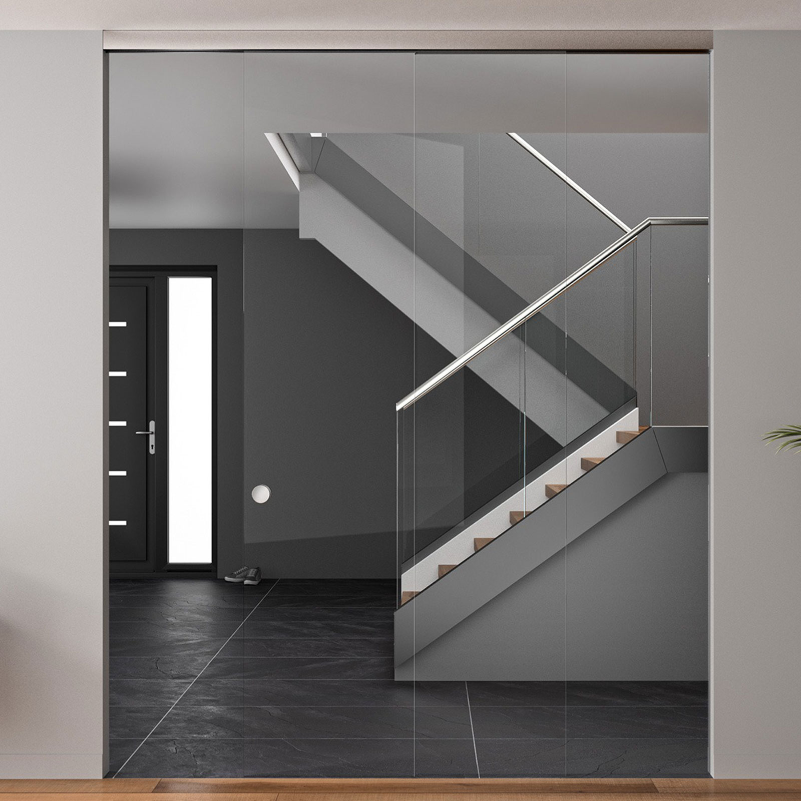 Ein dunkel gehaltener Eingansbereich mit Treppe, welche ein Glasgeländer besitzt.